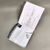 Vagrant Story for PlayStation 1 - Alternate view of open instruction booklet showing center pages with intact registration card and staple binding, like new condition