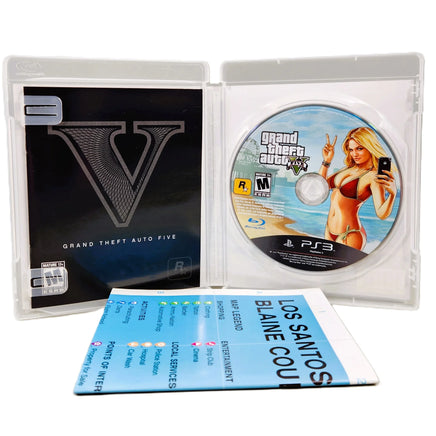 Grand Theft Auto V PlayStation 3 Very Good CIB - Open Case Showing Disc, Artwork, Instruction Manual, and Fold Out Map