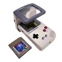 Nintendo Game Boy Console System Bundle with Tetris, & Light Magnifier, Very Good Loose - View showing Tetris Game next to Portable Game Console with High Frequency Light attached