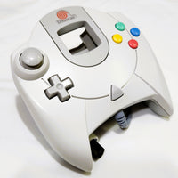 White Dreamcast OEM controller with colorful buttons on a white background