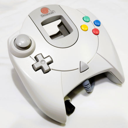 White Dreamcast OEM controller with colorful buttons on a white background