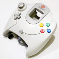 White Official Sega Dreamcast controller with colorful buttons on a white background