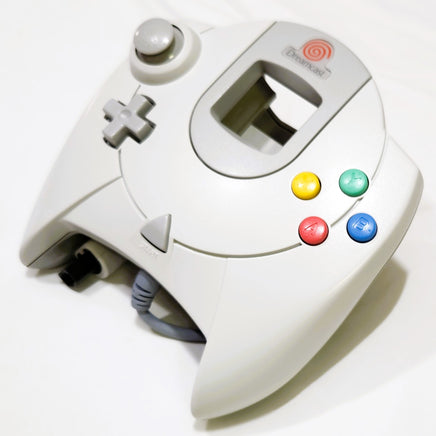 White Official Sega Dreamcast controller with colorful buttons on a white background