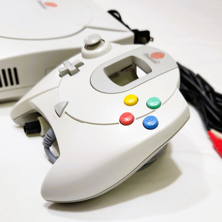 White Dreamcast gaming controller with colorful buttons on a white background