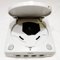 White Sega Dreamcast console with open lid on a white background